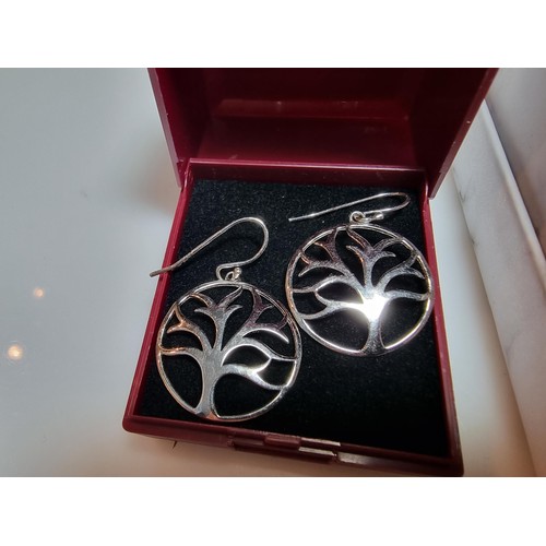 330 - A pair of unused 925 silver earrings with a tree design along with an unused gold plated deer pendan... 