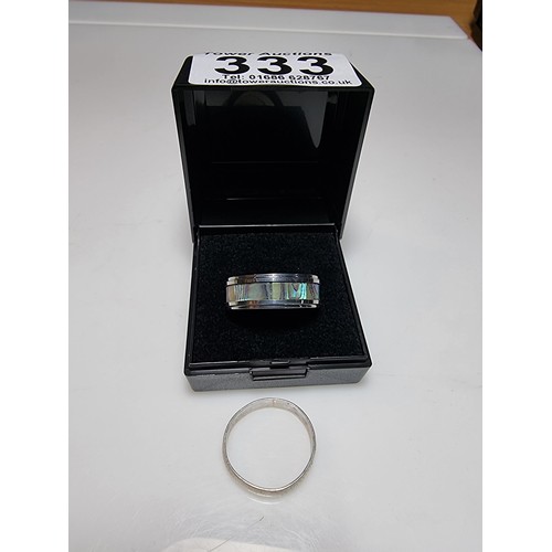 333 - An as new Tungsten carbide ring with colourful abalone shell all the way around along with a sterlin... 