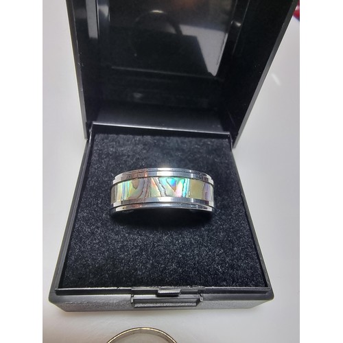 333 - An as new Tungsten carbide ring with colourful abalone shell all the way around along with a sterlin... 