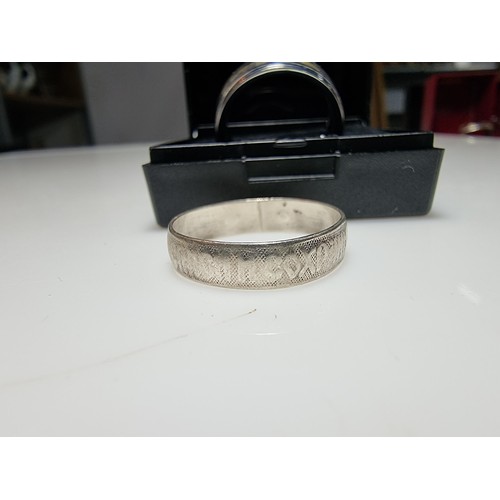 333 - An as new Tungsten carbide ring with colourful abalone shell all the way around along with a sterlin... 