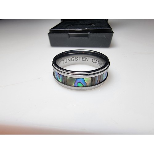 333 - An as new Tungsten carbide ring with colourful abalone shell all the way around along with a sterlin... 