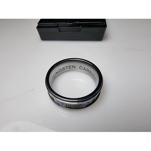 333 - An as new Tungsten carbide ring with colourful abalone shell all the way around along with a sterlin... 