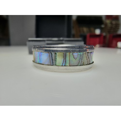333 - An as new Tungsten carbide ring with colourful abalone shell all the way around along with a sterlin... 