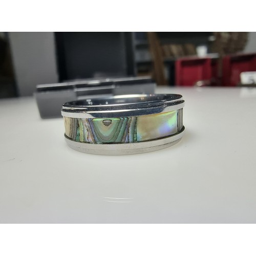 333 - An as new Tungsten carbide ring with colourful abalone shell all the way around along with a sterlin... 