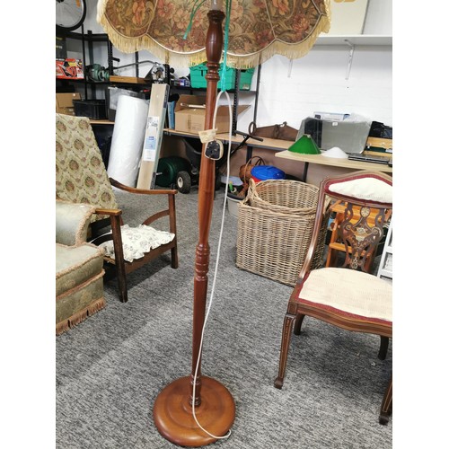 439 - Tall wooden standard lamp complete with multi coloured flora shade with tassels in good order, lamp ... 