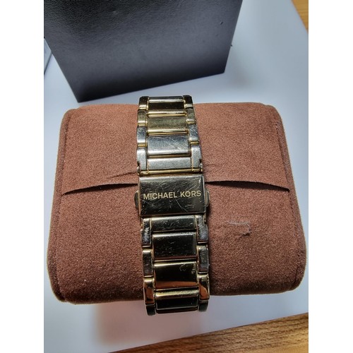 349 - An attractive unisex chronograph watch by Michael Kors with a jewelled bezel and gold tone strap, co... 