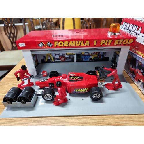 232 - A boxed formula one pitstop set by Dickie complete with figures, car and tyres missing one figure. T... 