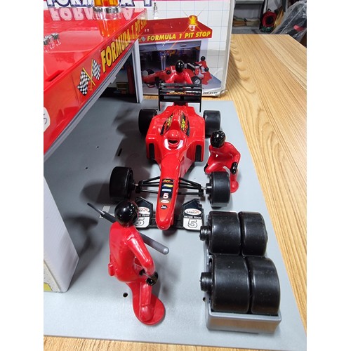 232 - A boxed formula one pitstop set by Dickie complete with figures, car and tyres missing one figure. T... 