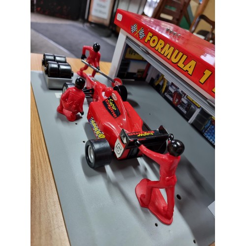 232 - A boxed formula one pitstop set by Dickie complete with figures, car and tyres missing one figure. T... 