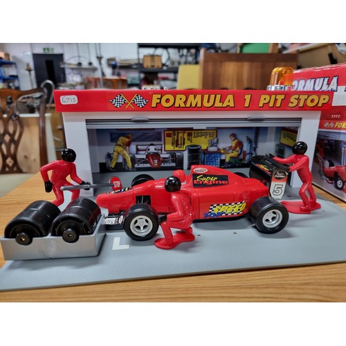 232 - A boxed formula one pitstop set by Dickie complete with figures, car and tyres missing one figure. T... 