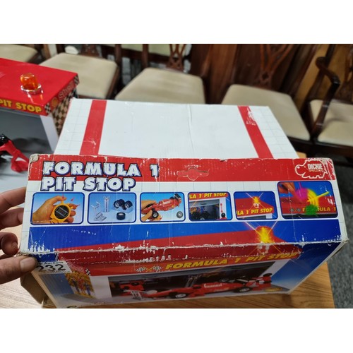 232 - A boxed formula one pitstop set by Dickie complete with figures, car and tyres missing one figure. T... 