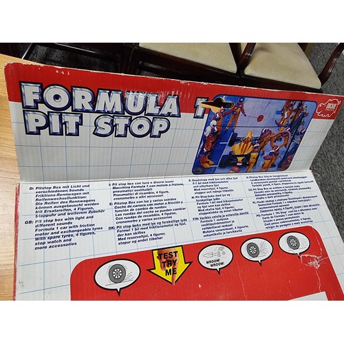 232 - A boxed formula one pitstop set by Dickie complete with figures, car and tyres missing one figure. T... 