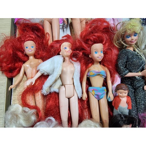 235 - A large quantity of various doll figures to include many Barbie dolls, some are earlier examples fro... 