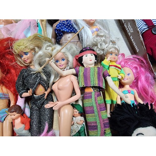 235 - A large quantity of various doll figures to include many Barbie dolls, some are earlier examples fro... 