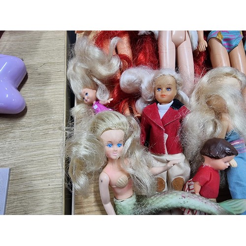 235 - A large quantity of various doll figures to include many Barbie dolls, some are earlier examples fro... 