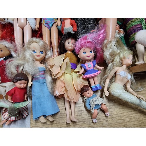 235 - A large quantity of various doll figures to include many Barbie dolls, some are earlier examples fro... 