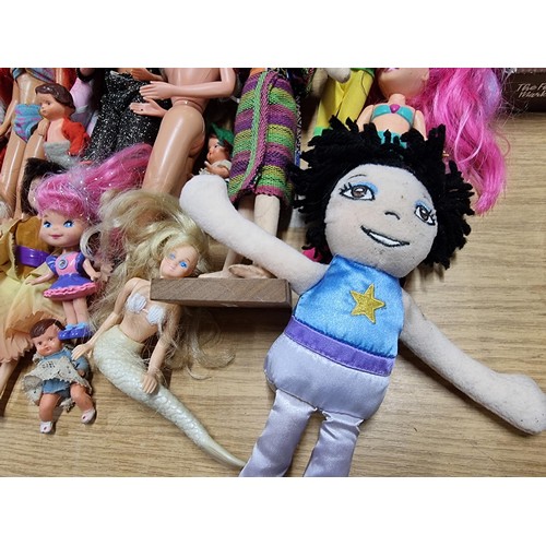 235 - A large quantity of various doll figures to include many Barbie dolls, some are earlier examples fro... 