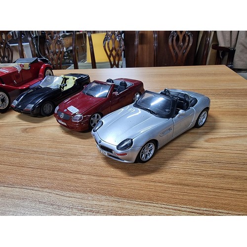 238 - A collection of model cars to include 4 large diecast model cars and 2 wooden model cars which inclu... 