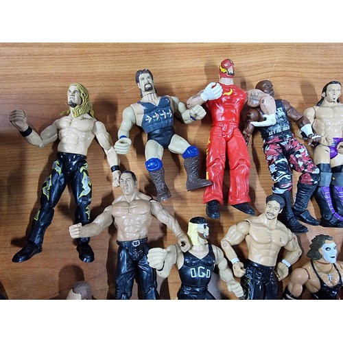 241 - A large collection of approx 26x action figures mostly of wrestlers from the early 2000's and on. To... 