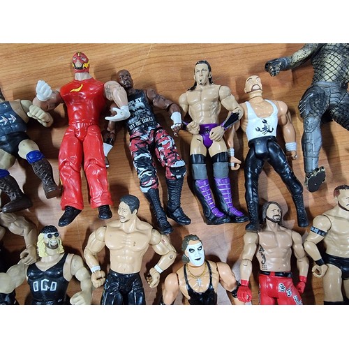 241 - A large collection of approx 26x action figures mostly of wrestlers from the early 2000's and on. To... 