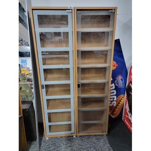 8 - Pair of glass front shelf units, each with 6 shelves some shelf pins are missing standing 123.5cm wi... 