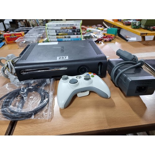 257 - An Xbox 360 games console complete with an Xbox controller and 10 good games, 120GB hard drive, in f... 