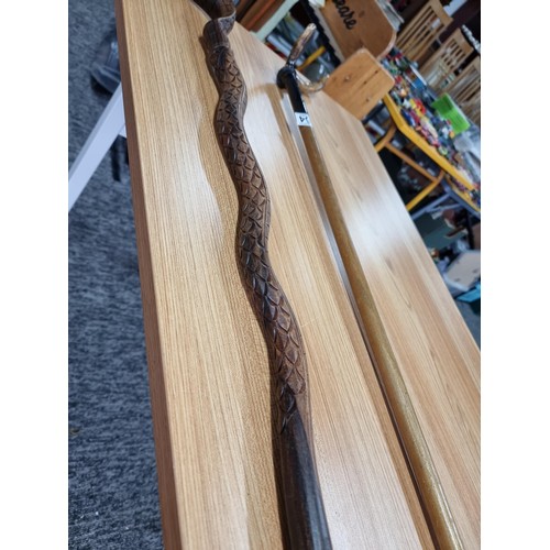 264 - 2 walking sticks, a carved cobra walking stick (has an old repair to the top) the other stick has an... 