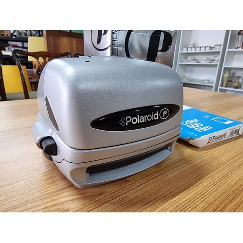 273 - A boxed polaroid camera complete with a new colour 600 film with 8 instant photos, in good condition... 