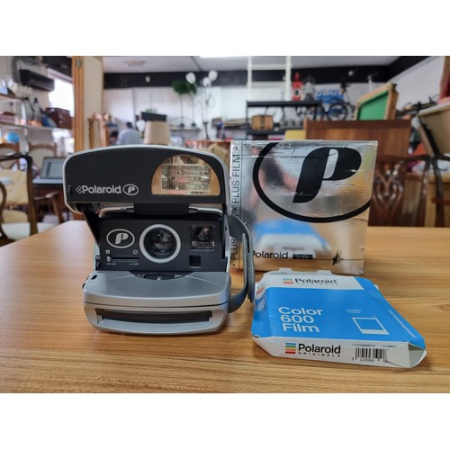 273 - A boxed polaroid camera complete with a new colour 600 film with 8 instant photos, in good condition... 