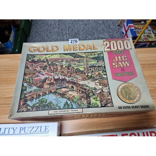 276 - A quantity of puzzles and board games along with 4x 1970's life magazines which includes 2x 2000 pie... 