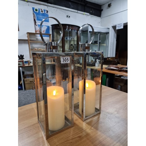 305 - 2 x Lantern lamps both stainless steel construction and both with battery operated pillar candles bo... 