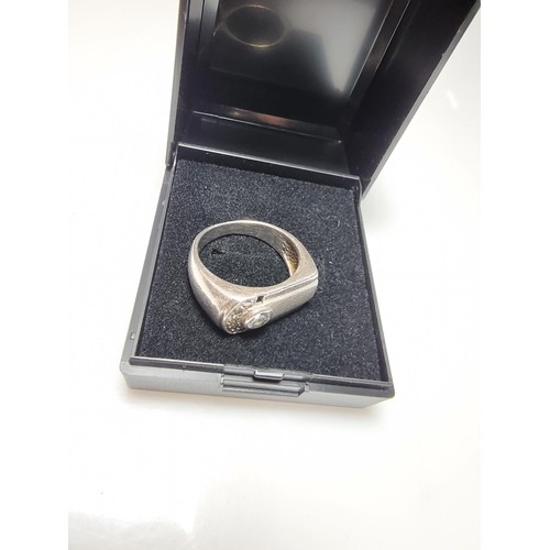 334 - A small gents 925 silver ring inset with sparkly CZ crystal stones. In clean condition and boxed. Si... 