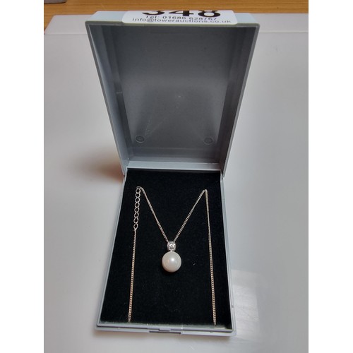 340 - A 925 silver faux pearl pendant with a CZ crystal stone set on an 18