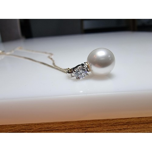 340 - A 925 silver faux pearl pendant with a CZ crystal stone set on an 18