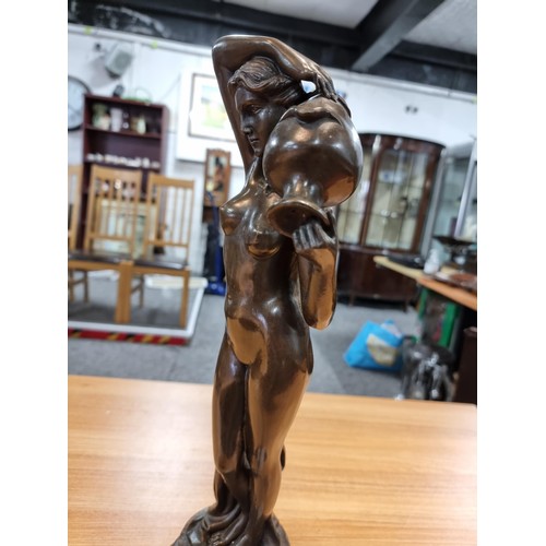 314 - A good solid bronze figure of a nude lady holding an amphora, presenting excellent detail throughout... 