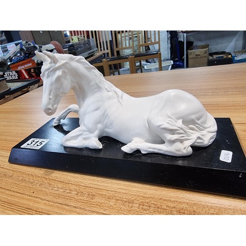 315 - A Beswick spirit of peace white horse on a black plinth, in god condition with no damage. Height of ... 