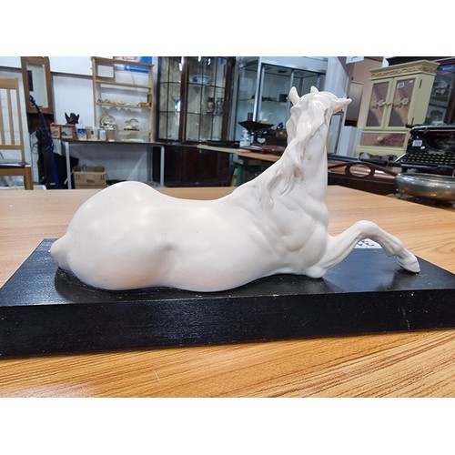 315 - A Beswick spirit of peace white horse on a black plinth, in god condition with no damage. Height of ... 