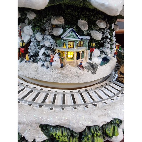 321 - A Thomas Kinkade wonderland express Christmas feature which includes moving trains which go around t... 