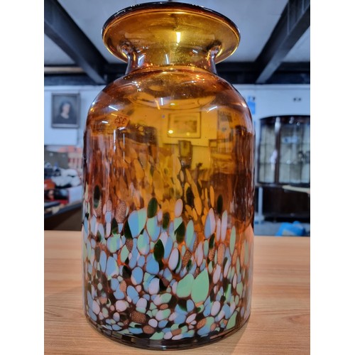 325 - A very large and impressive amber art glass vase with a colourful speckled design featuring greens, ... 