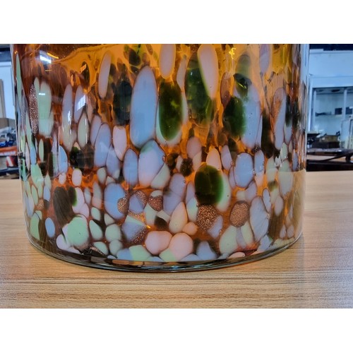 325 - A very large and impressive amber art glass vase with a colourful speckled design featuring greens, ... 