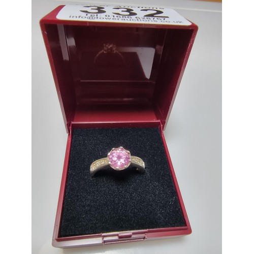 332 - An ornate 925 silver dress ring inset with a large pink crystal CZ stone and smaller clear CZ stones... 