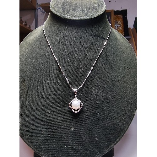 333 - A 925 silver pendant inset with a real pearl, set on a 16