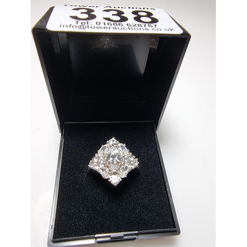 338 - An ornate as new 925 silver cluster dress ring inset with a large quantity of sparkly crystal CZ sto... 