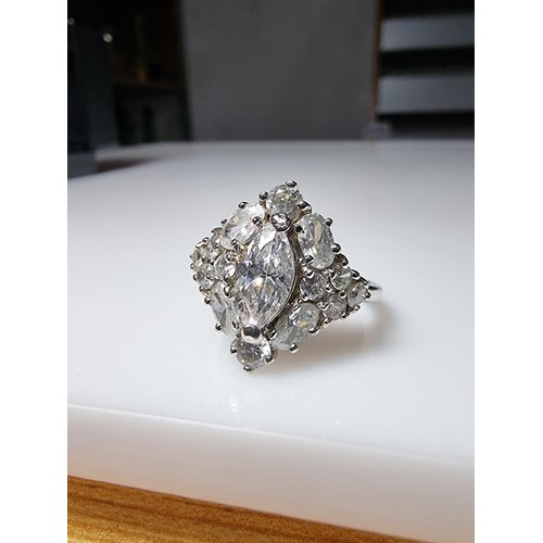 338 - An ornate as new 925 silver cluster dress ring inset with a large quantity of sparkly crystal CZ sto... 