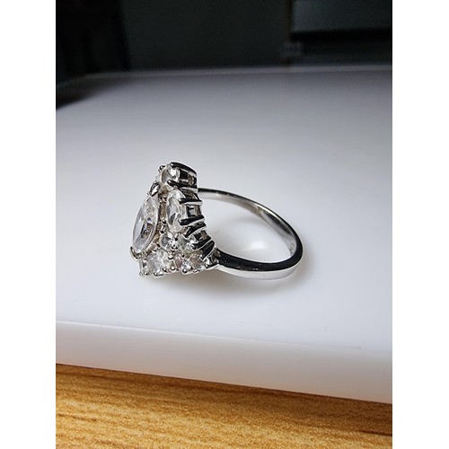 338 - An ornate as new 925 silver cluster dress ring inset with a large quantity of sparkly crystal CZ sto... 