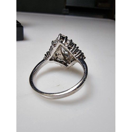 338 - An ornate as new 925 silver cluster dress ring inset with a large quantity of sparkly crystal CZ sto... 