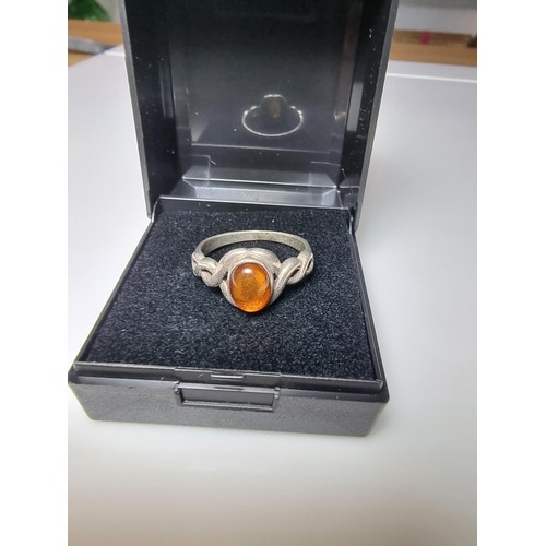 339 - A 925 silver ring inset with a genuine amber stone, in clean condition, boxed, size P.