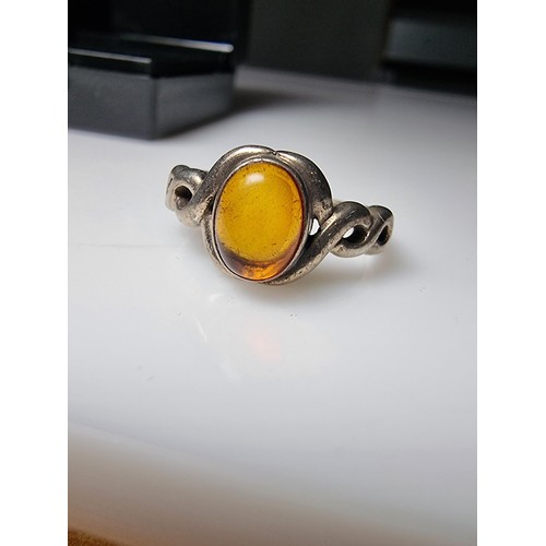 339 - A 925 silver ring inset with a genuine amber stone, in clean condition, boxed, size P.