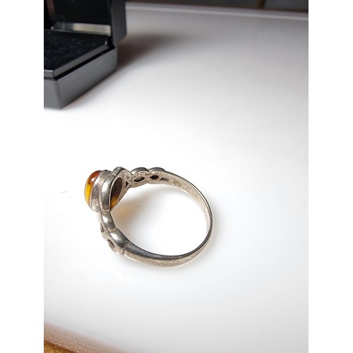 339 - A 925 silver ring inset with a genuine amber stone, in clean condition, boxed, size P.