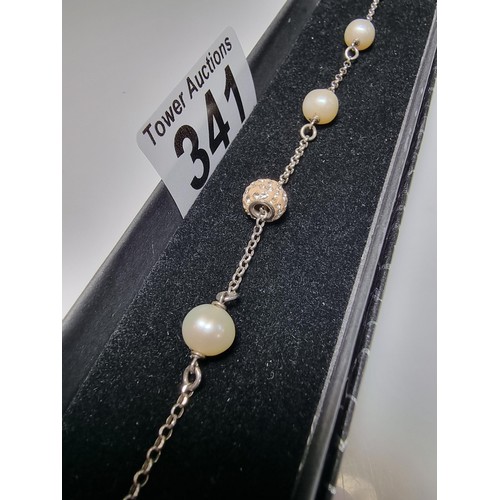 341 - A 925 silver bracelet inset with real pearls and a jewelled charm, total length of 8.5